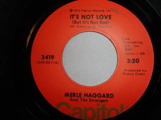 Merle Haggard And The Strangers (5) : It's Not Love (But It's Not Bad) / My Woman Keeps Lovin' Her Man (7", Single)