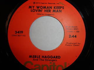 Merle Haggard And The Strangers (5) : It's Not Love (But It's Not Bad) / My Woman Keeps Lovin' Her Man (7", Single)